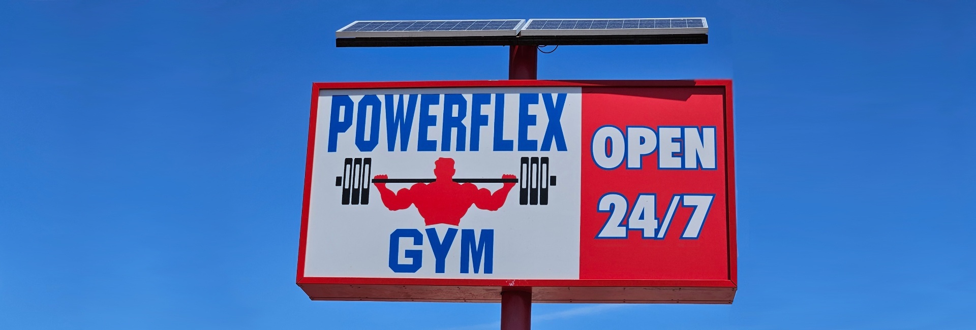 a sign for powerflex gym in albuquerque stating it is open 247